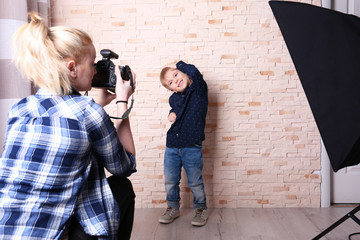 Small boy posing in front of photographer