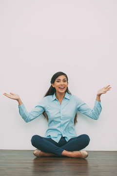 Woman Sitting on Floor with Outstretched Hands