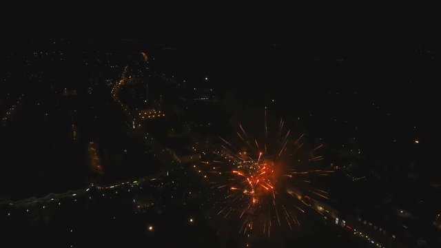 Aerial view Beautiful fireworks video from the drone in the night sky on celebration. Sparks. Fireworks are a class of explosive pyrotechnic devices used for aesthetic and entertainment purposes