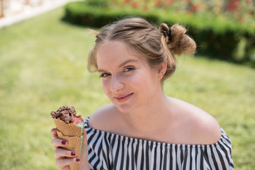 cute young woman holding ice cream cone 
