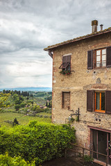 Typically italian landscape with old house on foreground, San Gimignano, Italy