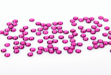 Precious sparkling rhinestones rose colors on a white background.