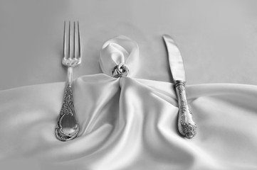 Solemn table setting. Vintage fork and knife. Vintage cutlery on white lace