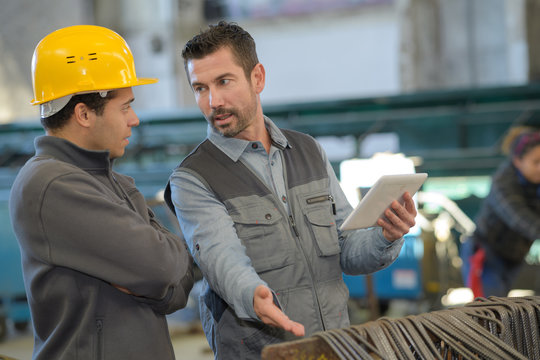 construction worker pointing at digital tablet close-up