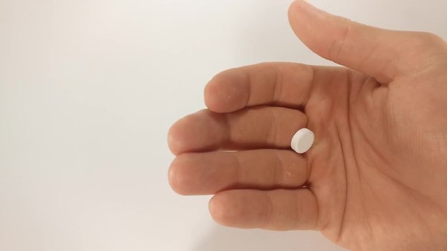 Man Taking white Pills from Blister Pack close up. Footage will work great for any videos dealing with healthcare, medical treatment  and much more.