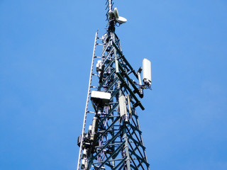 upper part of communication tower in front of blue sky