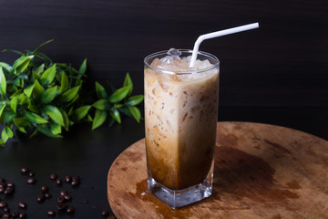 Pour ice coffee on dark background