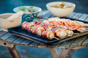 barbecue in the garden - summer- prawns and vegetables on skewers