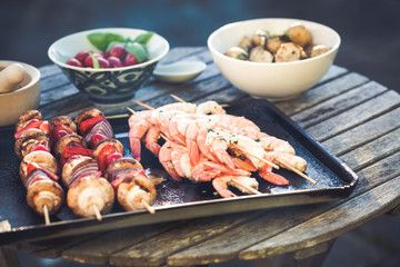 barbecue in the garden - summer- prawns and vegetables on skewers