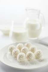 Coconut candy on a white plate with a white blurry background