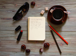 Top view of notebook and fashion accessories