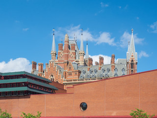 Outside view of the British Library building, national library of the UK in London, with the gothic towers of St Pancras Railway Station behind the wall.