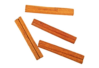 Four cinnamon sticks on a white background, top view