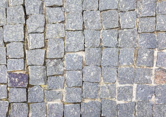 Texture of cobblestone road close-up.