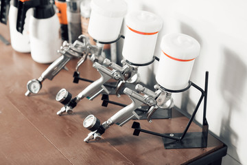 spray gun on wood table. in auto service. used for industrial painting and coating
