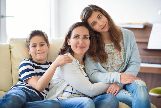 Portrait of pretty young mother with her tennager daughter and son