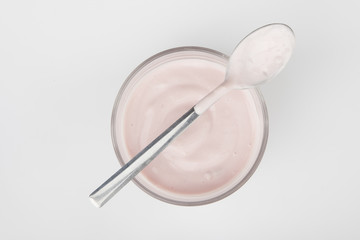 glass of fresh berries and yogurt isolated on white background