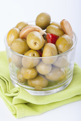 Bowl of homemade olives on a glass, typical spanish tapa, isolated on white background