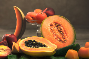 summer and tropical orange fruits over wood