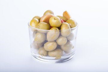 Bowl of homemade olives on a glass, typical spanish tapa, isolated on white background