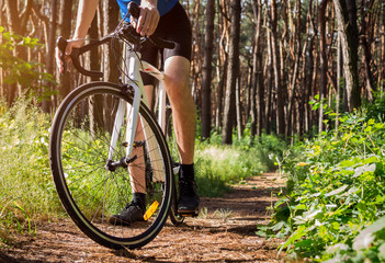 Fototapeta na wymiar Young bicyclist riding in the forest