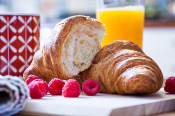 delicious continental breakfast of orange juice and croissants
