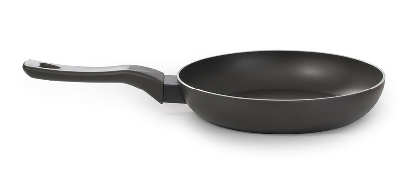 Empty black frying pan, isolated on white background, side view, close up.