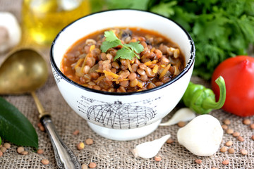 Vegetarian soup from boiled lentils, mushroom, tomatoes, carrots, onions and garlic.