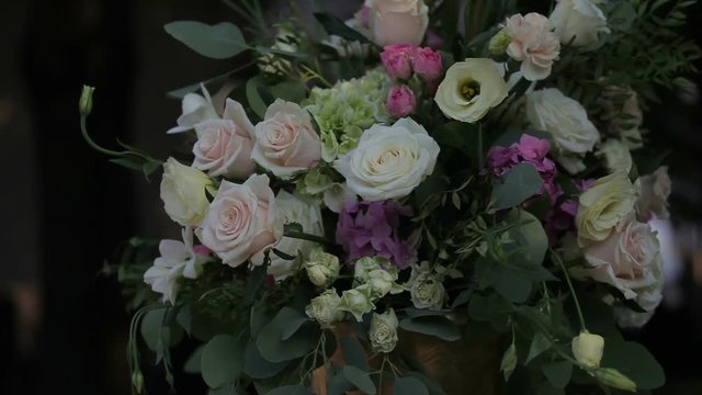  Flower Arrangement in Vase. Flower arrangement bouquet standing in vase on table. Close view of colorful flowers. Fresh pink roses, white carnation, green grass, amazing herbs. Close up