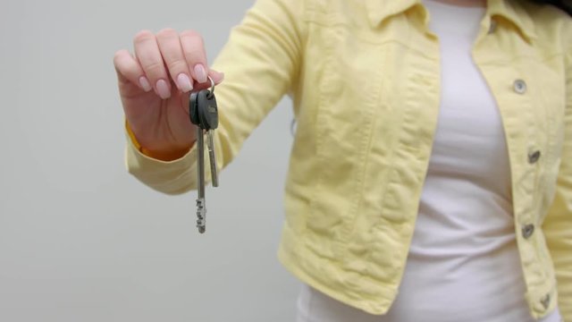 The girl is holding the keys to the camera.