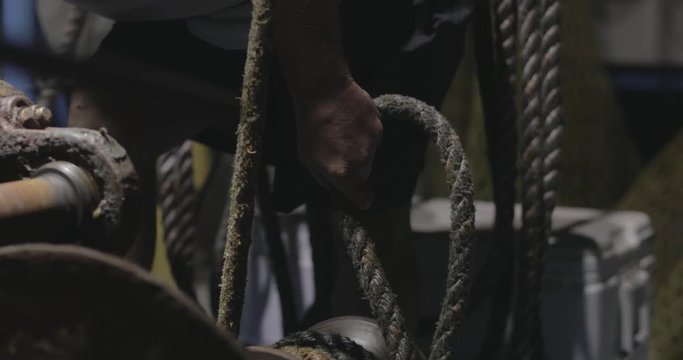 Sailor holding ropes on a boat