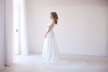Fototapeta na wymiar bride in wedding dress in a white room