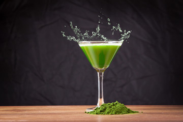 Young barley and chlorella spirulina, water splash. Detox superfood.
