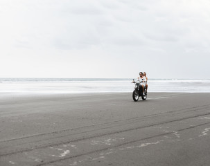 Fototapeta premium Young beautiful couple riding motorcycle