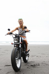 Fototapeta na wymiar Girl sitting on vintage custom motorcycle
