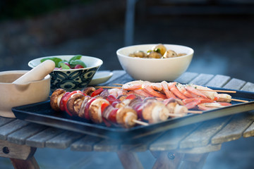 barbecue in the garden - summer- prawns and vegetables on skewers