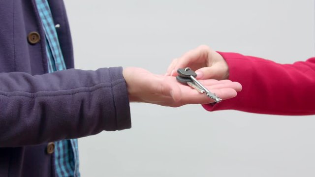The man hands over the keys to the woman