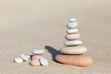 Fototapeta na wymiar Stones balance on sand background