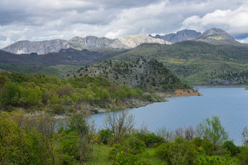 Naklejka na ściany i meble Beautiful mountain lake in Spain, Asturias region in summer, with dramatic sky and a lot of clouds