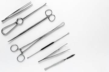 Medical instruments for plastic surgery on white backgrond top view copyspace