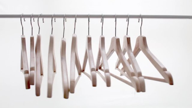 Wooden bright hangers for coat and dress on the rack