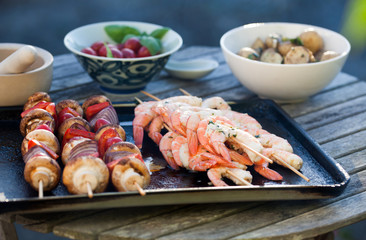 barbecue in the garden - summer- prawns and vegetables on skewers
