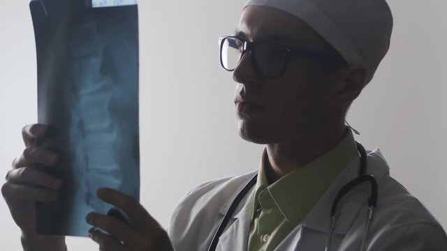 The doctor is studying an X-ray. Medical worker diagnoses