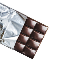 Bitter, dark chocolate bar in foil isolated on white background, top view