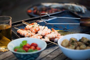 barbecue in the garden - summer- prawns and vegetables on skewers