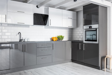 Gray kitchen with brick wall