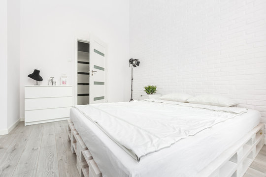 Bedroom with white brick wall