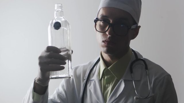 Portrait of Drunk doctor. A medical worker drinks vodka.