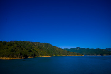Fototapeta na wymiar Beautiful landscape with gorgeous blue sky in a sunny day seen from ferry from north island to south island, in New Zealand