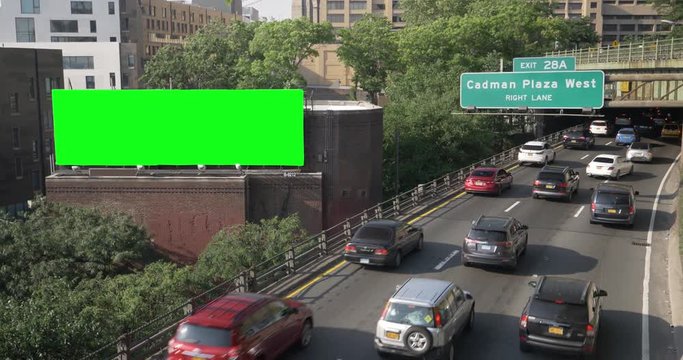 A high angle daytime establishing shot of the Cadman Plaza West exit off the Brooklyn Queens Expressway in New York City. Green screen billboard for custom content.  	